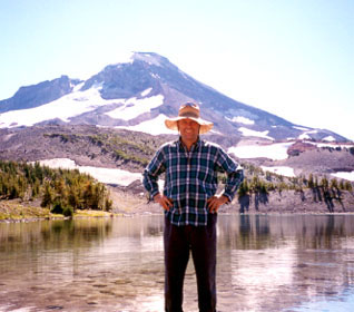 Chris Maser standing in front of a Mountain